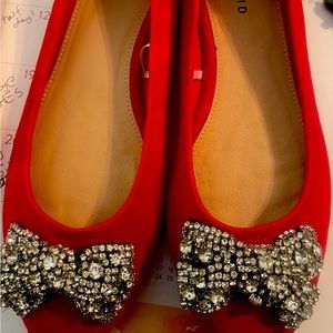 Red beautiful flats with bedazzled bow.